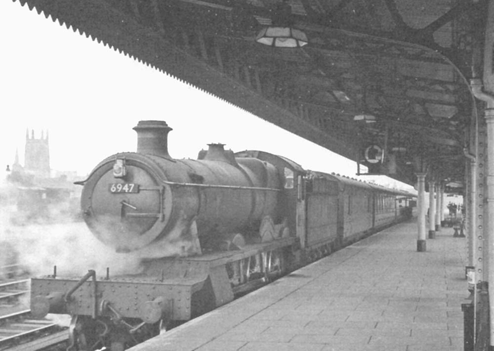 Ex-GWR 49xx Class 4-6-0 No 6947 'Helmingham Hall' stands at Leamington's down platform on 16th February 1957