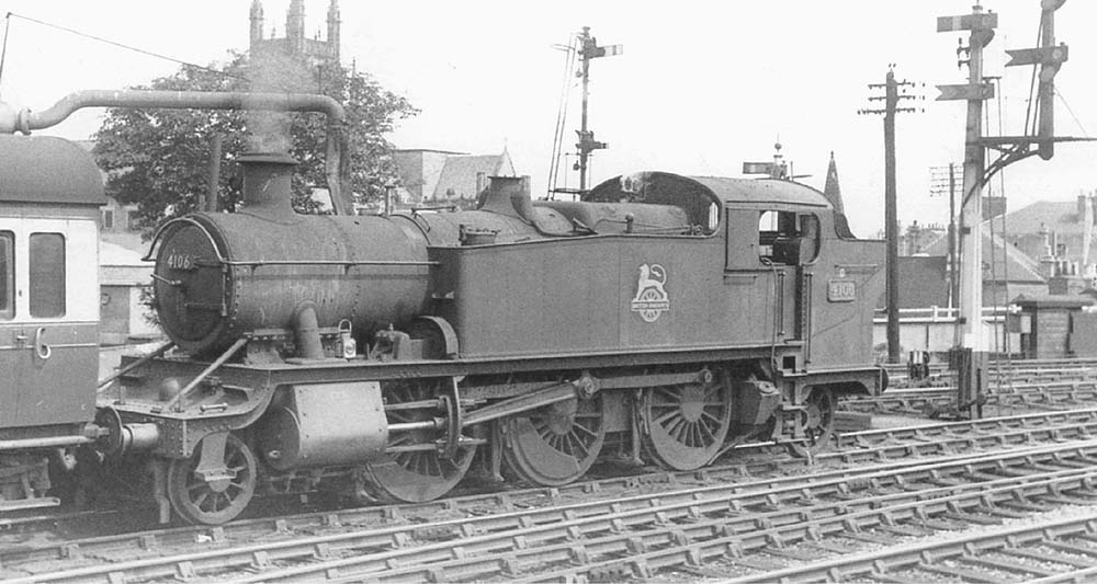 Ex-GWR 5101 Class 2-6-2T No 4106 stands bunker first at the head of an up local service on 4th August 1951