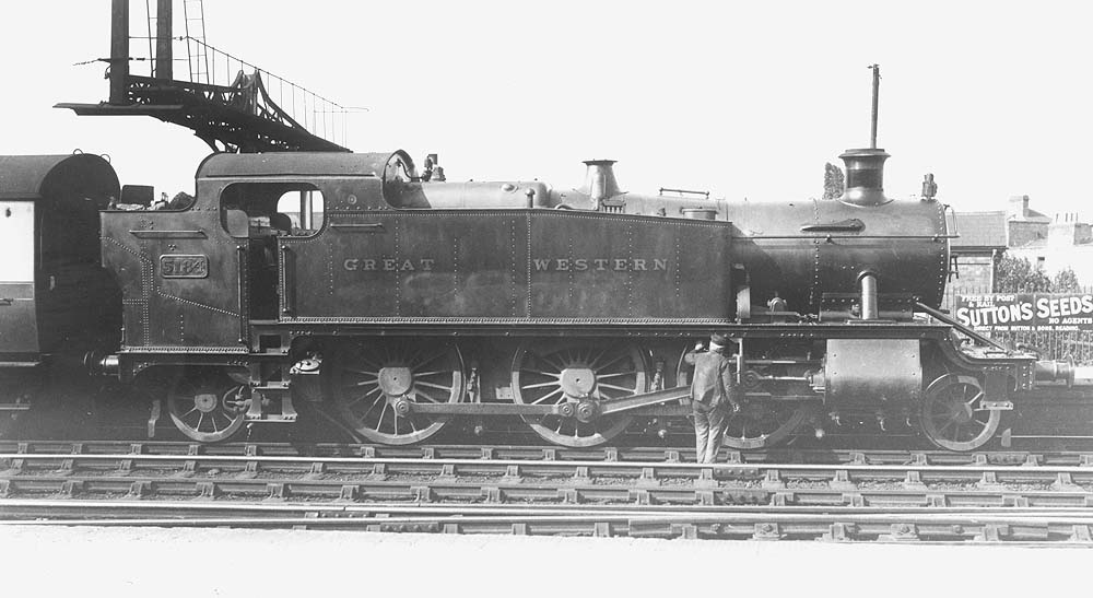GWR 2-6-2T 'Large Prairie' No 5184 stands at the head of an up local passenger train whilst the driver attends to a little oiling