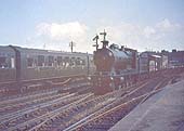 An unidentified ex-ROD or GWR 3100 class 2-8-0 passes through the station on down goods train