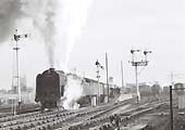British Railways Standard Class 9F 2-10-0 No 92203 is seen piloting an unknown diesel on a down service to Snow Hill