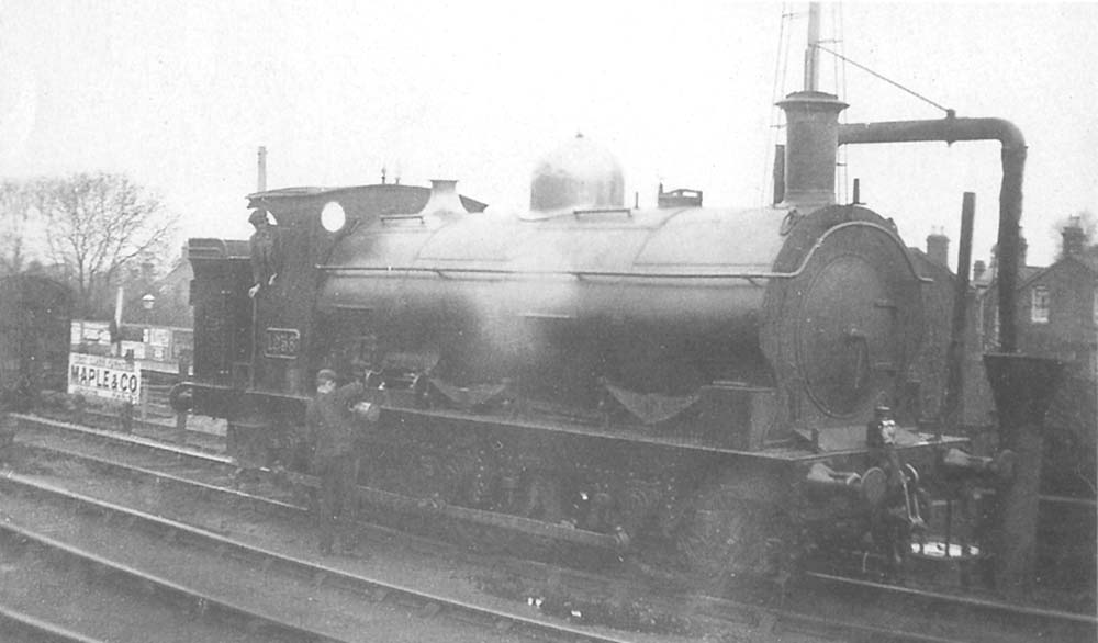 GWR 0-6-0 '1076' class saddle tank No 1258 receiving attention by the water column on the goods loop