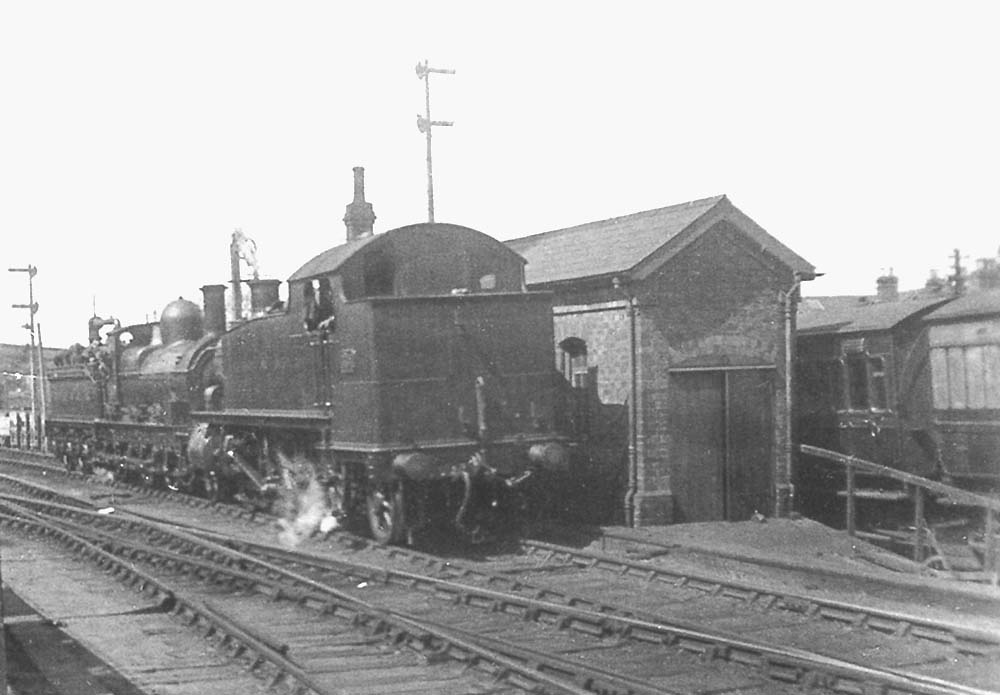 Unidentified GWR '31xx' class 2-6-2T and GWR 0-6-0 'Standard Goods' are seen in the goods loop