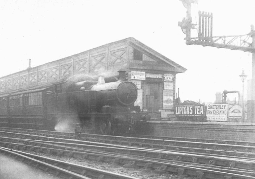 GWR 36xx class 2-4-2T arrives at the down platform on a lengthy train of six and four-wheel coaching stock