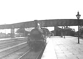 A GWR 2-4-0, possibly a '3226' class locomotive waits at the down platfor with a Birmingham bound local train