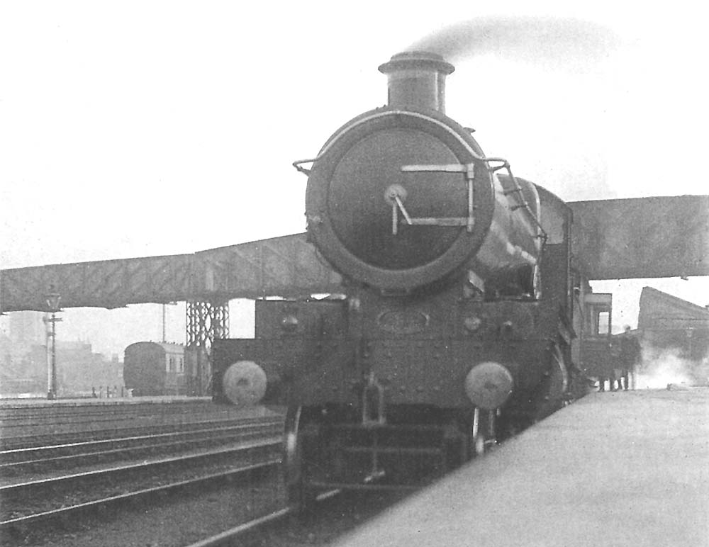 GWR 4-4-0 No 3803 'County Cork', based at Paddington, stands at the down platform at the head of a express