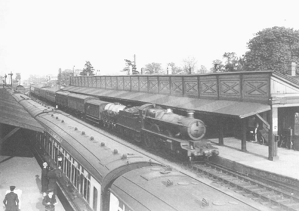 GWR 4-6-0 Star class thought to be No 4015 'Knight of St John' arrives at the down platform at the head of a Paddington to Shrewsbury parcels train