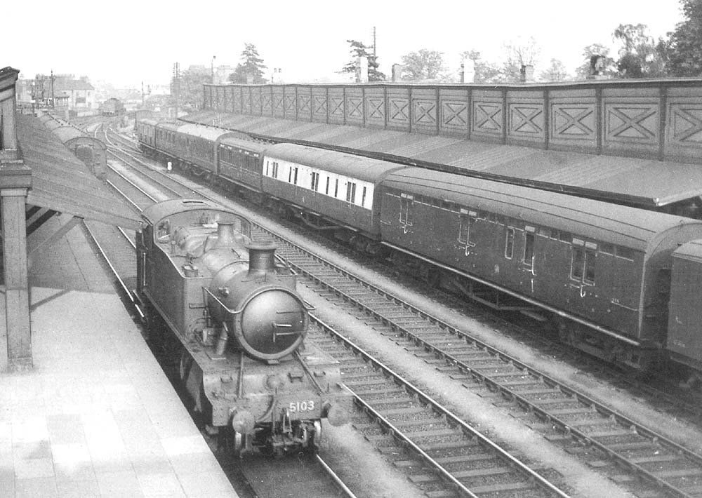 GWR 2-6-2T 'Large Prairie' No 5103 allocated to Tyseley shed stands at the up platform alongside the Paddington to Shrewesbury parcels train