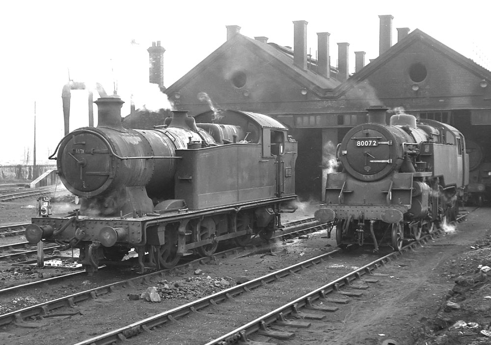 Ex-GWR 56xx Class 0-6-2T No 6671 and British Railways 4MT 2-6-4T No 80072 stand outside the shed on 13th Match 1965