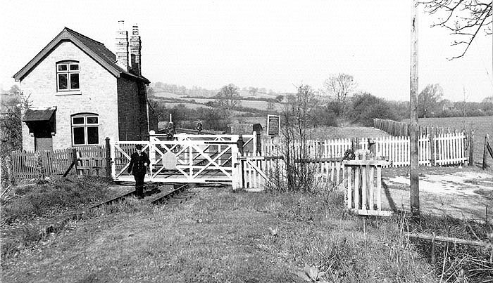 A 1950s view looking towards the goods yard with the branch to Moreton-in-Marsh curving to the left beyond the level crossing gates