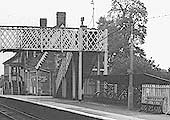 Close up showing the cycle shed erected at the base of the passenger footbridge with BR totem signs on the lamppost