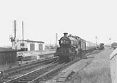 An unidentified ex-GWR 4-6-0 Castle class locomotive is seen at the head of the up 'Cornishman' as it passes a train standing in the refuge siding