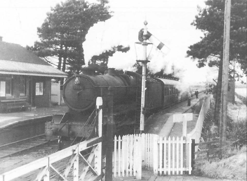 Ex-GWR 4-6-0 County class No 1014 'County of Glamorgan' stands at Milcote with a down local passenger service