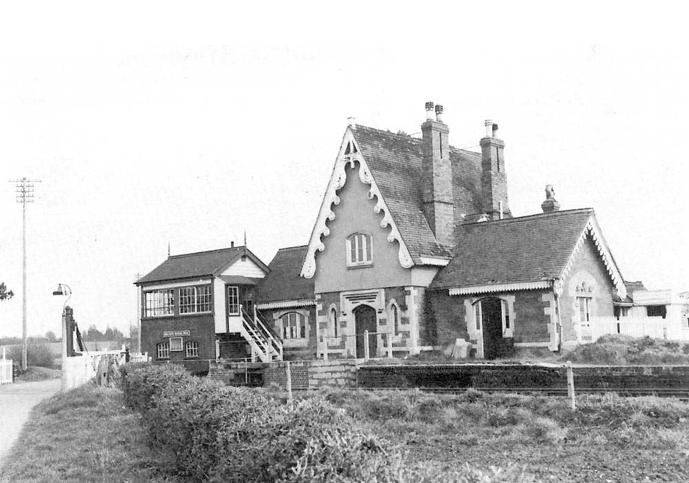 Broadside view of the original 1859 Milcote station and short platform with the signal box and level crossing on the left