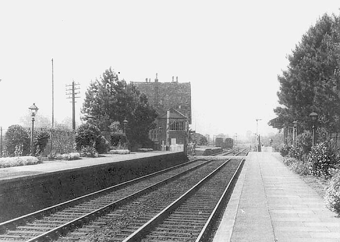 Looking towards Honeybourne along the up platform with the goods yard in the distance on the left beyond the 1859 station