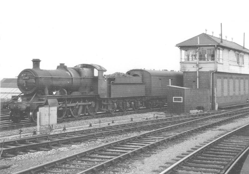 Ex-GWR 2-6-0 No 6340 is seen at the head of a parcels train as it passess from the down relief life line on to the down main line