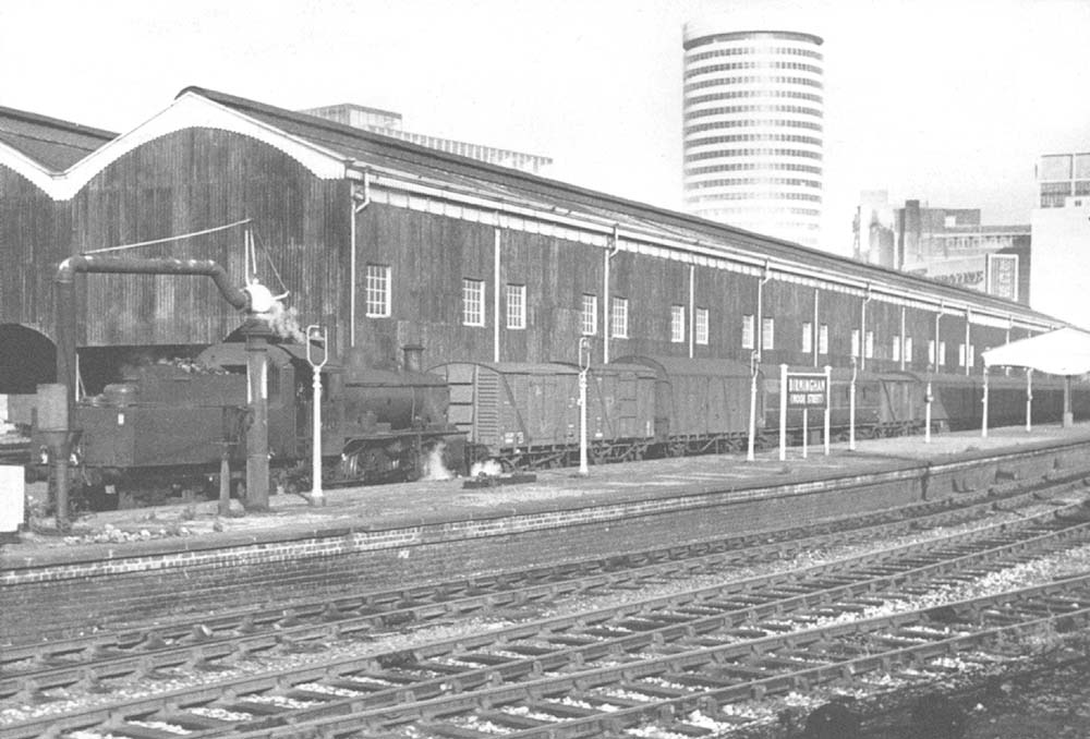 Ex-LMS 2MT 2-6-0 No 46457 is seen shunting wagons and parcel vans adjacent to Moor Streets upper goods shed in June 1966