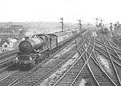 Ex-GWR 4-6-0 No 6014 'King Henry VII' is seen on a down express service as it passes the junction of Moor Street station