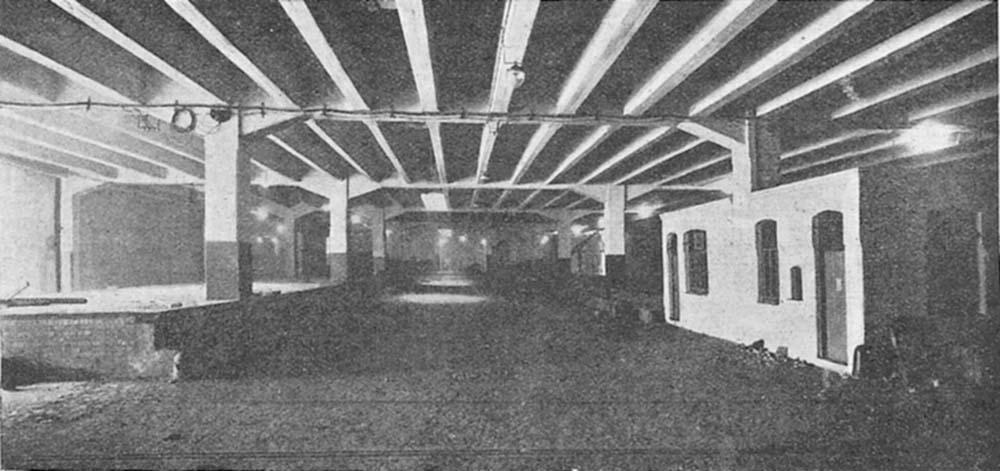 An internal view of lower shed 'A' still under construction showing the unloading platform on the left, the roadway in the centre and the office on the right