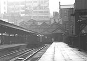 Close up view of the terminus end of the platform showing three miscellaneous vehicles standing next to the traverser