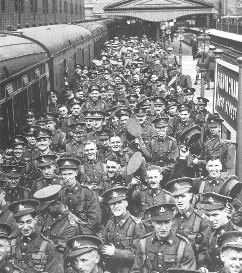 Territorials from the Royal Warwickshire Regiment are boarding GWR coaches assembled to form a troop train at Moor Street station