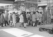 A group of morning commuters are seen going through Moor Street's ticket barrier on 30th April 1969