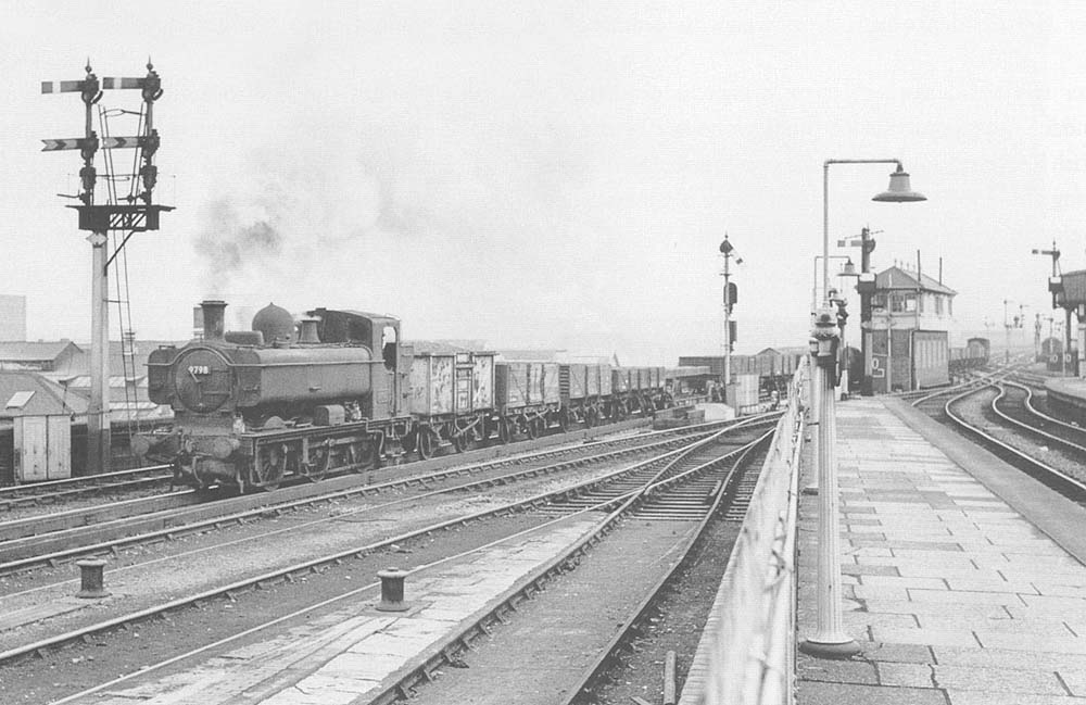 Ex-GWR 0-6-0PT No 9798 is seen crossing slowly from the down relief line to the down main line