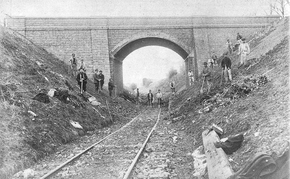 View of the consruction gang bringing the Shipton branch up to standard as they pose beneath the 'New Bridge' carrying Camden Road over the railway