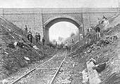 View of the consruction gang bringing the Shipton branch up to standard as they pose beneath the 'New Bridge' carrying Camden Road over the railway