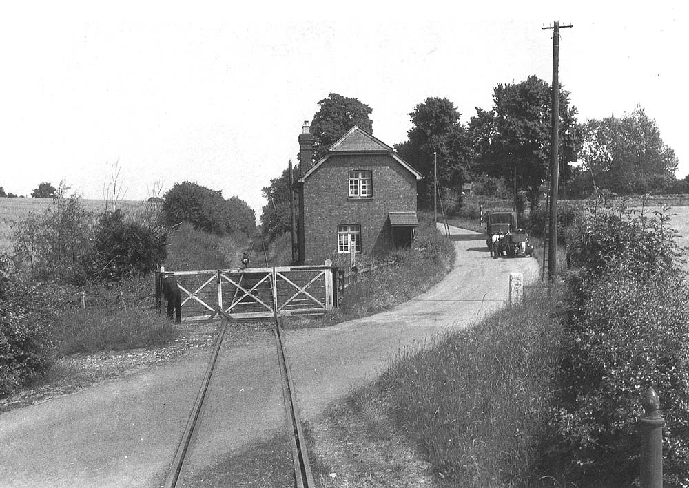 View of Shipston Road Level Crossing being closed by the guard as seen from the rear of his brake van with the gate keeper's house on the right
