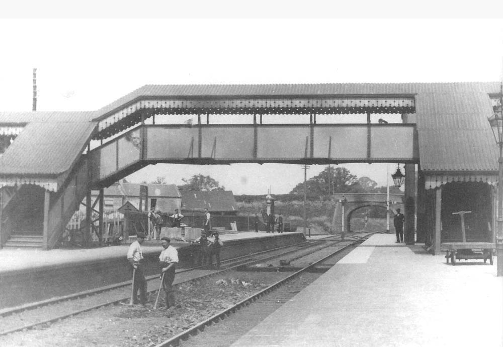 A gang of men from the Great Western Railway's Civil Engineering Department are working on both the platform and track bed