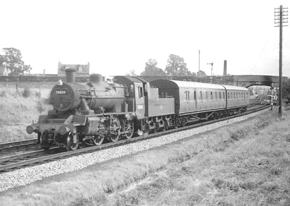 British Railways 2-6-0 2MT No 78008 is seen on a down stopping train north of the station on 11th October 1958