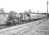 British Railways 2-6-0 2MT No 78008 is seen on a down stopping train north of the station on 11th October 1958
