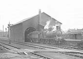 An unidentified GWR 0-6-0 'Dean Goods' locomotive is seen shunting wagons into the goods shed