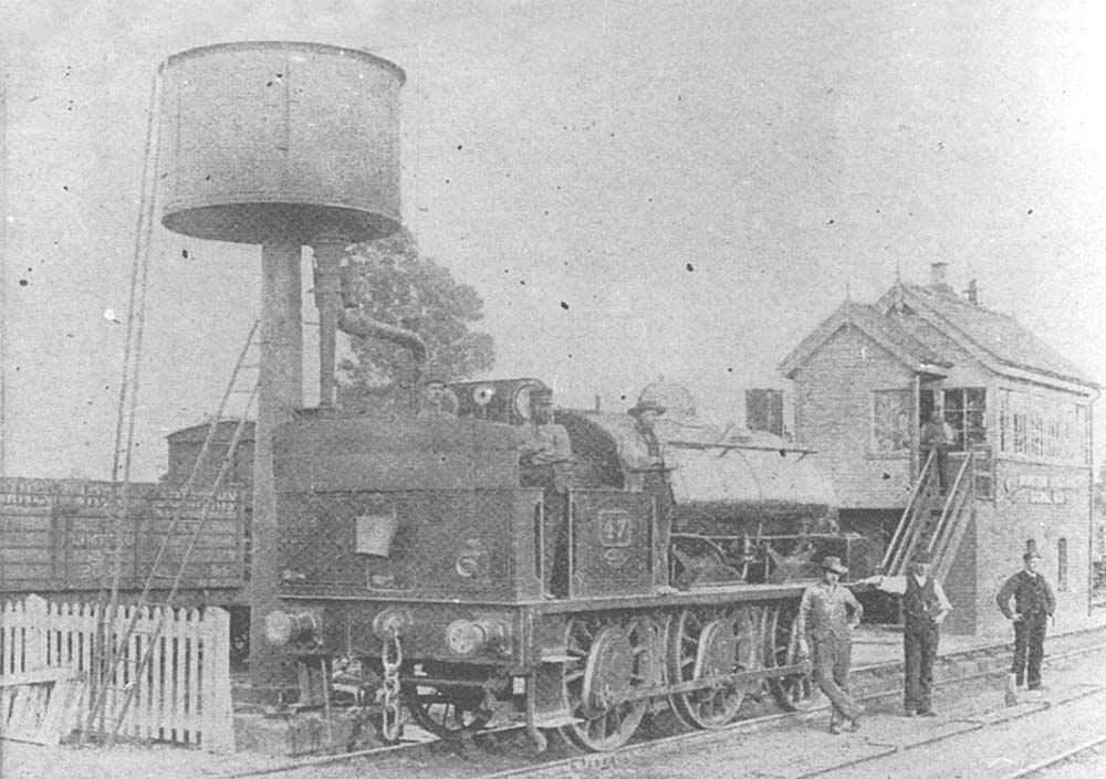 View of the Shipston-on-Stour branch locomotive, GWR 0-6-0ST No 47, standing under the water tank at Moreton-in-Marsh