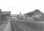 Looking towards Worcester from the Oxford end of the down platform with a substantial number of milk churns standing on the platform