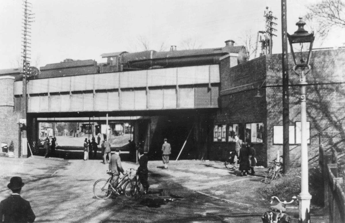 The photograph shows the static load test being performed on the plate girder bridge over Grange Road / Station Road