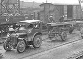 View of the travelling crane loading one of the GWR's mechanised tractor and trailer at Queens Head yard in the early 1930s