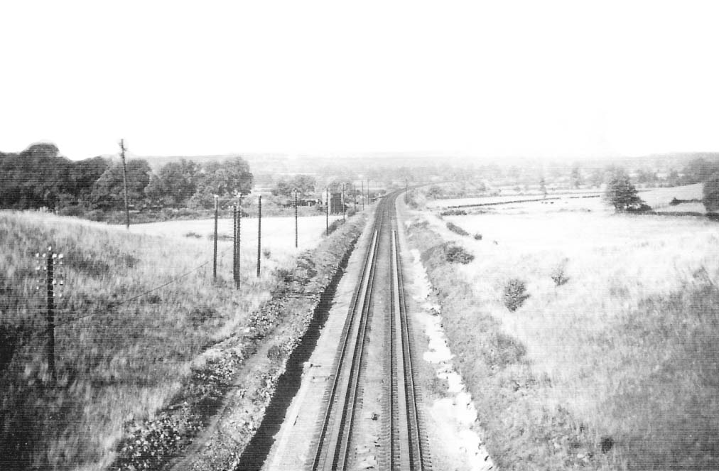 A view of the water troughs looking north towards Birmingham from the occupation bridge with Rowington Junction Signal Box in background