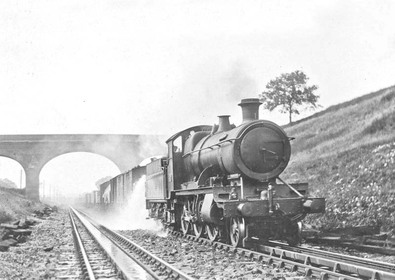Great Western Railway 2-6-0 43xx class mogul No.4320, with a class H ‘through freight’ train, drenches the first wagon and the permanent way