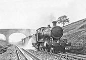 Great Western Railway 2-6-0 43xx class mogul No.4320, with a class H �through freight� train, drenches the first wagon and the permanent way