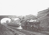 An unknown Great Western Railway 4-6-0 four cylinder 40xx 'Star' class locomotive with a modest five coach up-express