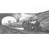 An unknown GWR 4-4-0 County Class locomotive passes over Rowington troughs on an up service
