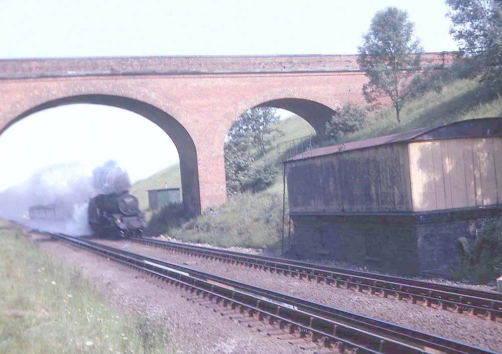 An unknown ex-LMS 4-6-0 Class 5 passes Rowington Troughs on a southbound passenger service on 17th July 1965