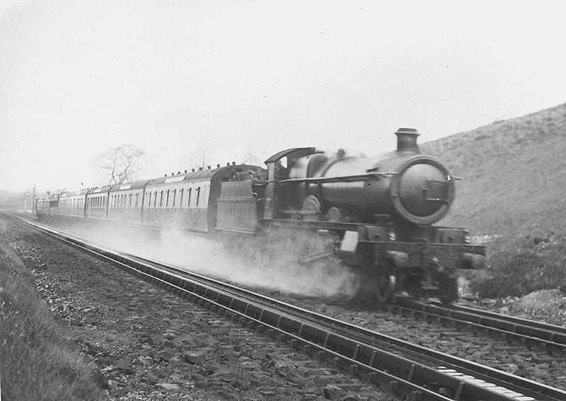 GWR 4-6-0 Saint class No 2977 'Robertson' is seen on a Birkenhead to Paddington service as it picks up water at Rowington Troughs