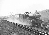 GWR 4-6-0 Saint class No 2977 'Robertson' is seen on a Birkenhead to Paddington service as it picks up water at Rowington Troughs