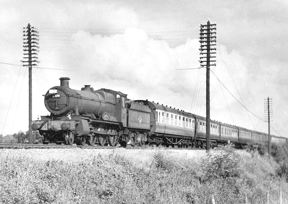Ex-GWR 4-6-0 No 6879 'Overton Grange' is seen passing through Rowington on an express service circa 1960