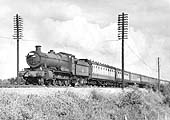 Ex-GWR 4-6-0 No 6879 'Overton Grange' is seen passing through Rowington on an express service circa 1960