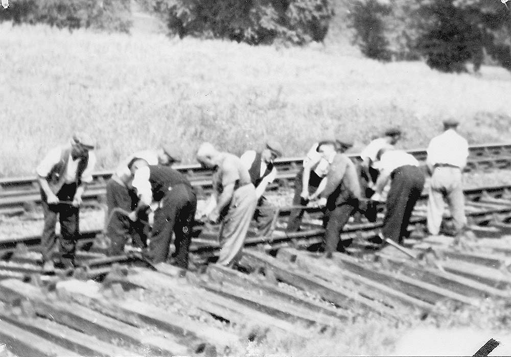 A gang of platelayers are seen at work on the main line near to Rowington Junction Signal Box in 1950