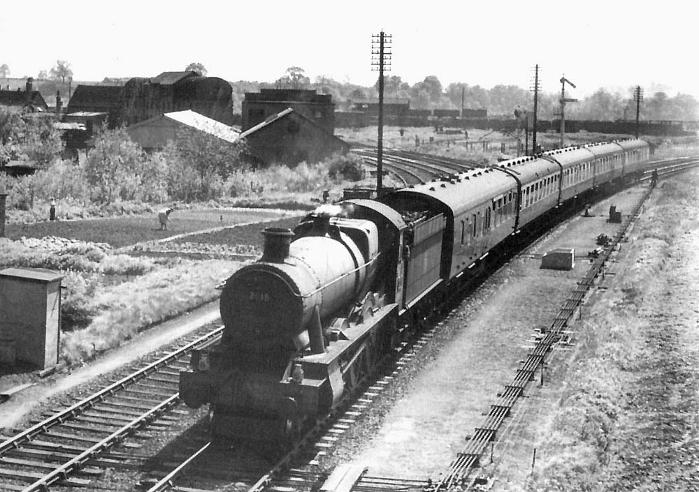 British Railways built 4-6-0 Modified Hall No 7918 'Rhose Wood Hall is seen on a Class  A five-coach up express passing the exchange line with the former SMJ line
